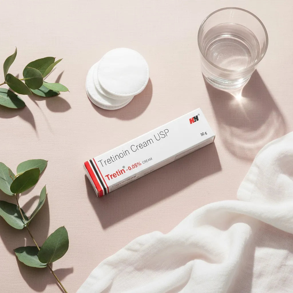 Tretin 0.05% Cream USP by H&H — product flat lay with natural leaves, cotton pads, and towel for skincare presentation.
