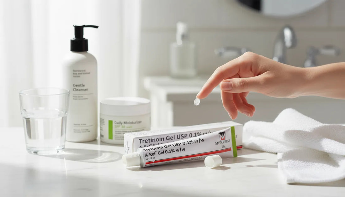 Hand applying A-Ret Tretinoin Gel USP 0.1% w/w by Menarini with cleanser and moisturizer on bathroom counter.