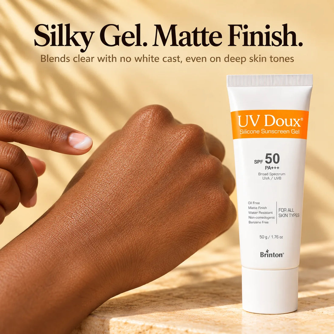 UV Doux Silicone Sunscreen Gel silky texture on a fingertip, blending clear with no white cast on deep skin